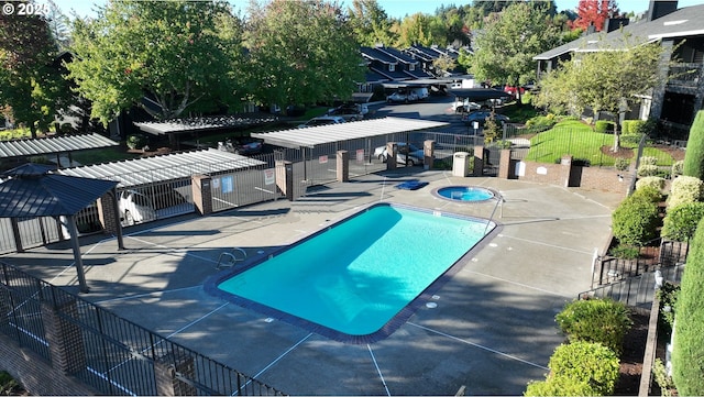 view of pool with a patio and a hot tub