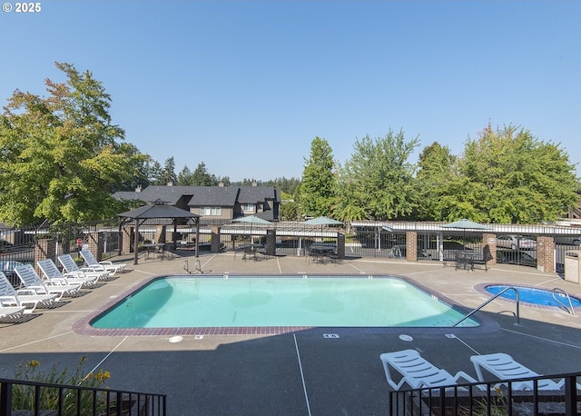 view of swimming pool with a gazebo and a patio area