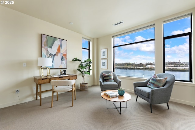 1660 NW Riverscape Dr, Portland, OR 97209 - living area featuring carpet floors, plenty of natural light, and a water view