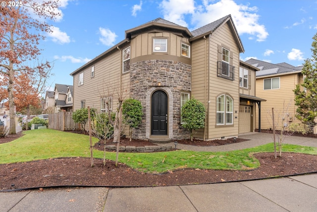 view of front of property featuring a front lawn and a garage