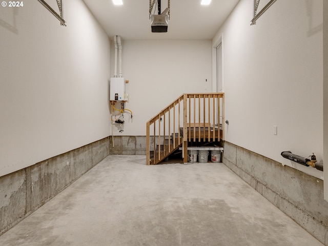 garage with a garage door opener and tankless water heater