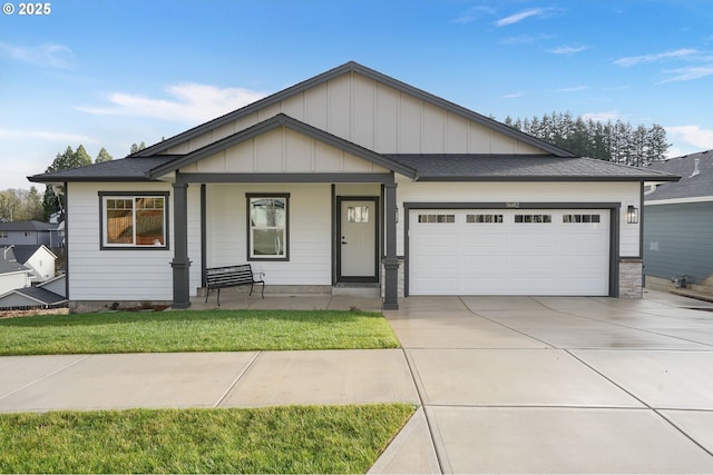 view of front facade with a garage, a front yard, and a porch