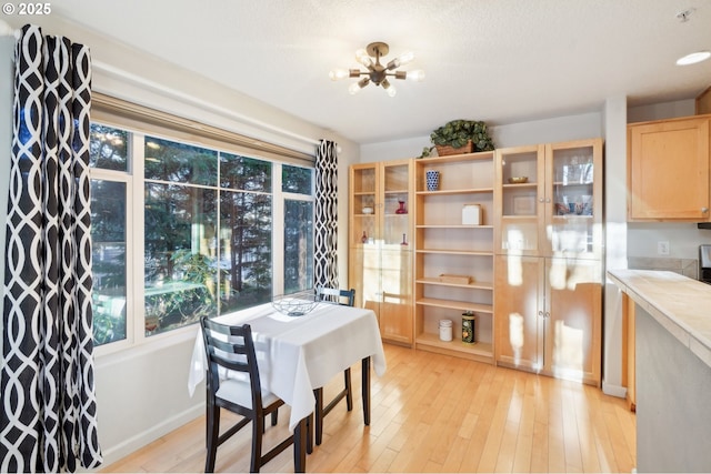 dining area featuring a notable chandelier and light wood-type flooring