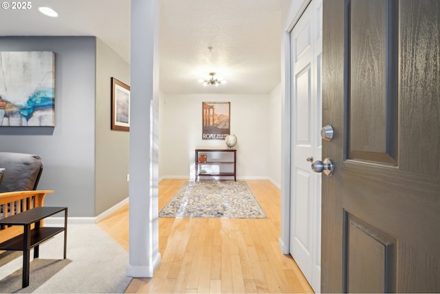 entryway with light hardwood / wood-style floors and a textured ceiling