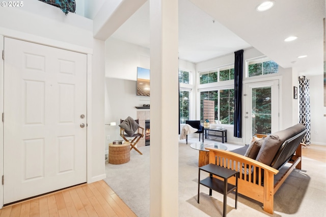 foyer featuring light hardwood / wood-style floors and a tile fireplace