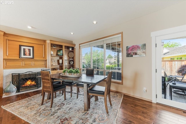 16706 NW Waterford Way, Portland, OR 97229 - dining area with wood-type flooring, healthy amount of natural light, recessed lighting, and a premium fireplace