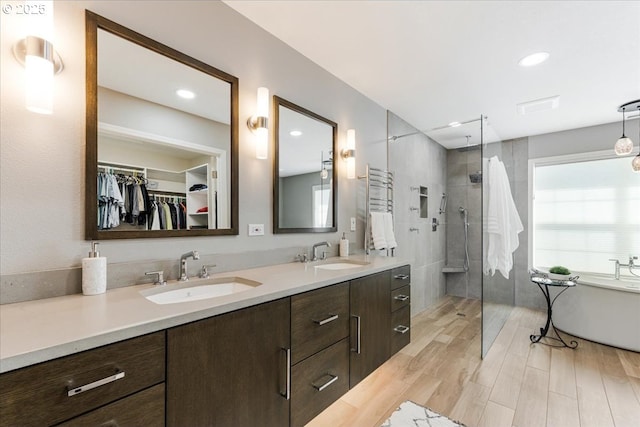 16706 NW Waterford Way, Portland, OR 97229 - full bath featuring a tile shower, double vanity, a freestanding tub, healthy amount of natural light, and recessed lighting