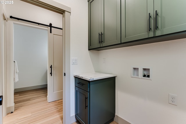 2110 Labona Dr, Eugene, OR 97404 - laundry room featuring cabinet space, washer hookup, light wood-type flooring, and a barn door