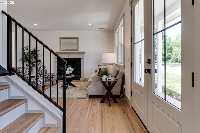 2110 Labona Dr, Eugene, OR 97404 - entrance foyer with stairs, light wood-style floors, a high end fireplace, and recessed lighting