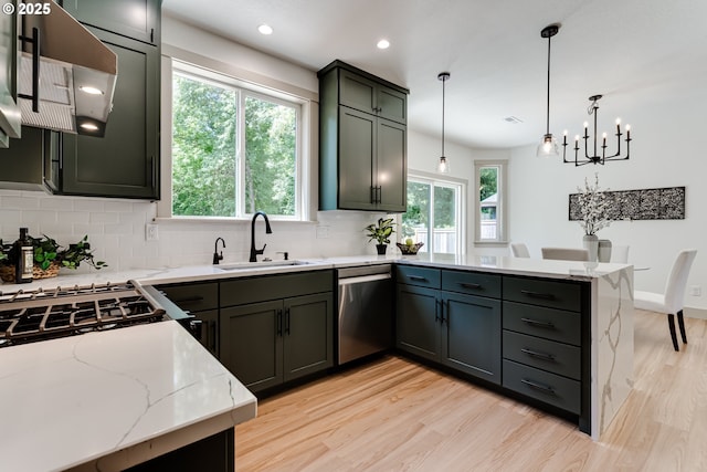 2110 Labona Dr, Eugene, OR 97404 - kitchen with stainless steel dishwasher, a peninsula, light wood-style flooring, decorative backsplash, and plenty of natural light
