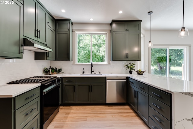 2110 Labona Dr, Eugene, OR 97404 - kitchen featuring dishwasher, black gas range oven, under cabinet range hood, a peninsula, and decorative backsplash