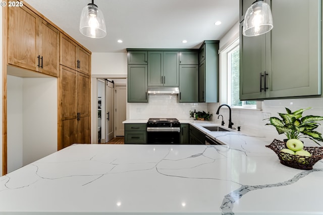 2110 Labona Dr, Eugene, OR 97404 - kitchen featuring stainless steel gas range, green cabinetry, under cabinet range hood, light stone countertops, and recessed lighting
