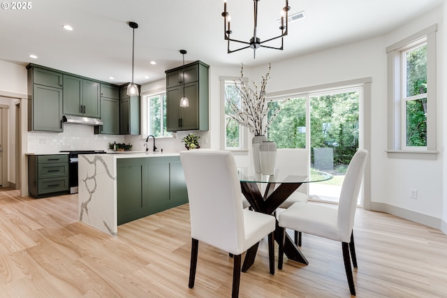 2110 Labona Dr, Eugene, OR 97404 - dining space with light wood-style flooring, a chandelier, and recessed lighting