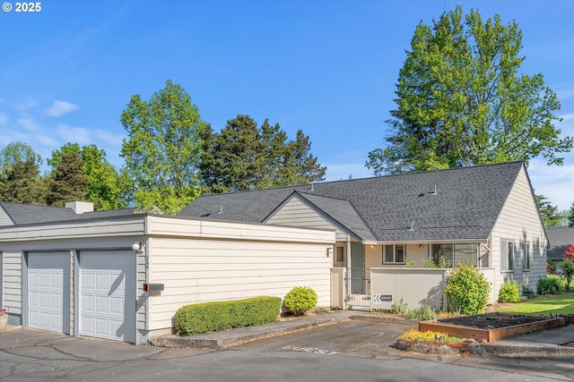 110 NE Village Squire Ave Unit 12, Gresham, OR 97030 - view of front of property featuring an attached garage, a shingled roof, and asphalt driveway