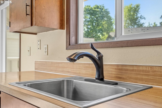 110 NE Village Squire Ave Unit 12, Gresham, OR 97030 - kitchen view of a sink, a textured wall, and light countertops