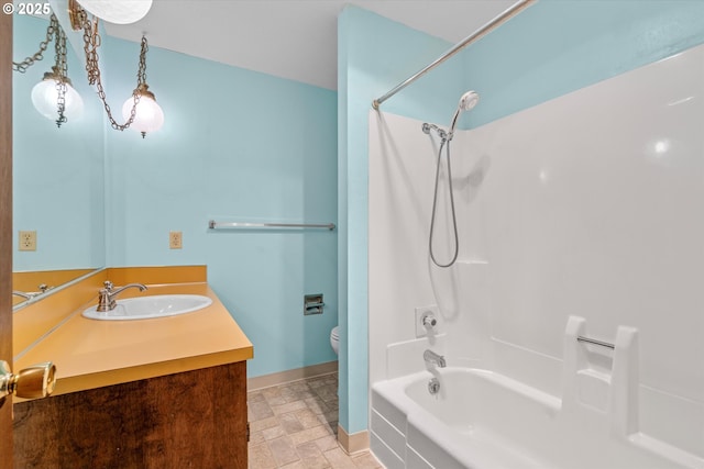 110 NE Village Squire Ave Unit 12, Gresham, OR 97030 - bathroom featuring toilet, vanity, bathtub / shower combination, baseboards, and stone finish floors