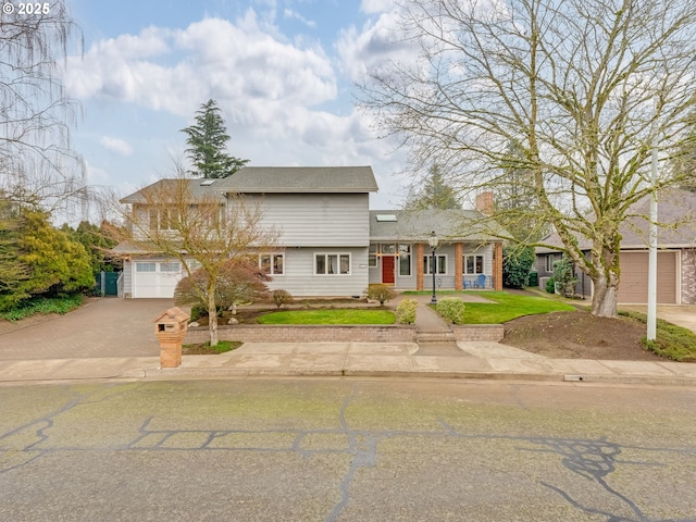 view of front facade with a garage and a front lawn