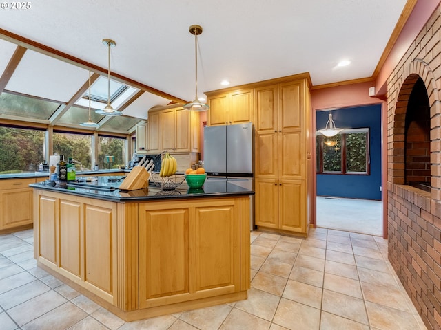 kitchen featuring dark countertops, lofted ceiling, a kitchen island, freestanding refrigerator, and pendant lighting