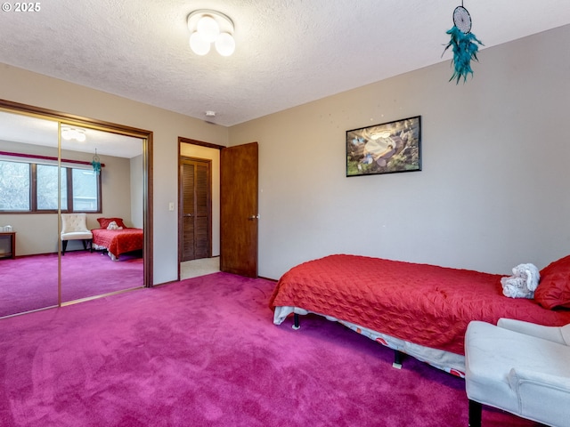 bedroom featuring a textured ceiling and carpet