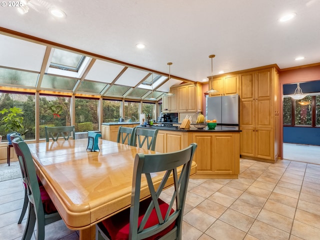 dining area with light tile patterned floors and vaulted ceiling