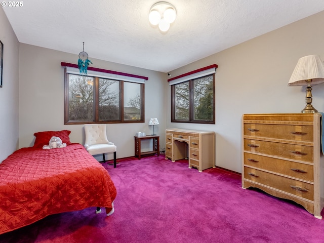 bedroom with carpet floors and a textured ceiling