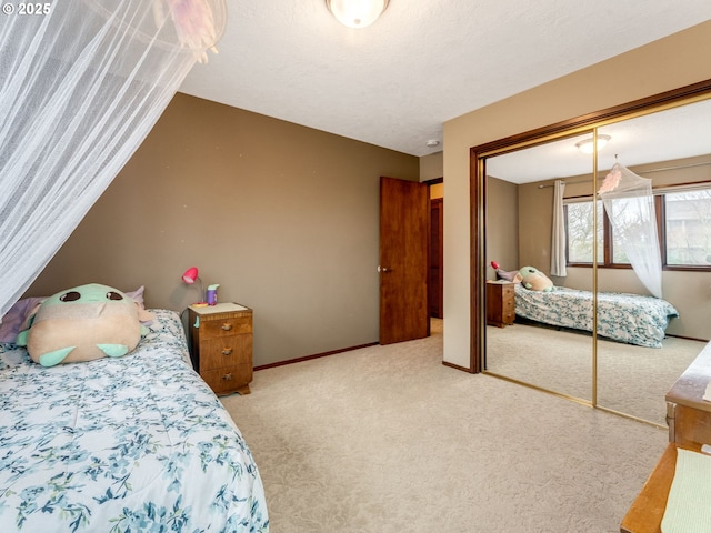 bedroom featuring carpet, a textured ceiling, baseboards, and a closet