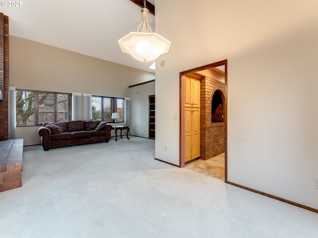 living room with light colored carpet and high vaulted ceiling