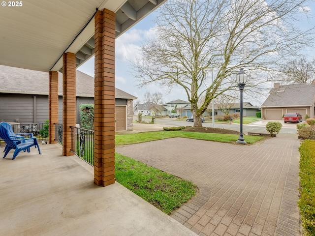 view of patio / terrace featuring a porch and a residential view