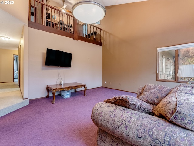 living room with a towering ceiling and carpet