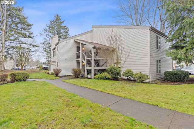 view of front of property featuring stairs, a chimney, and a front lawn