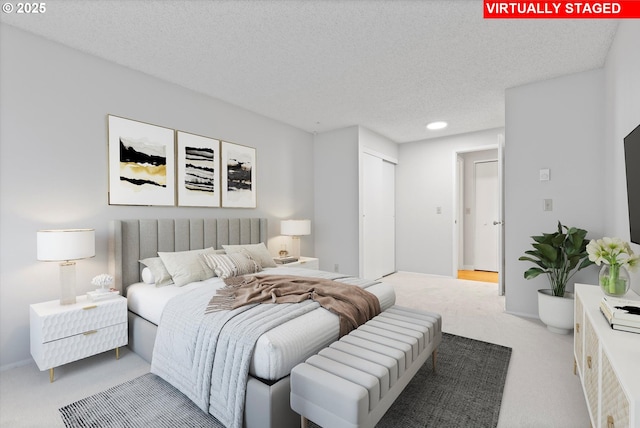 bedroom featuring carpet floors, a closet, and a textured ceiling