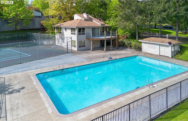 pool featuring fence and a patio