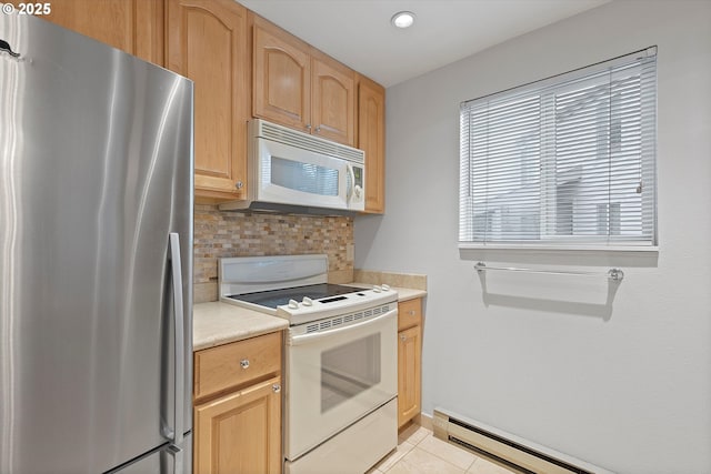 kitchen with white appliances, baseboard heating, light countertops, backsplash, and light tile patterned flooring