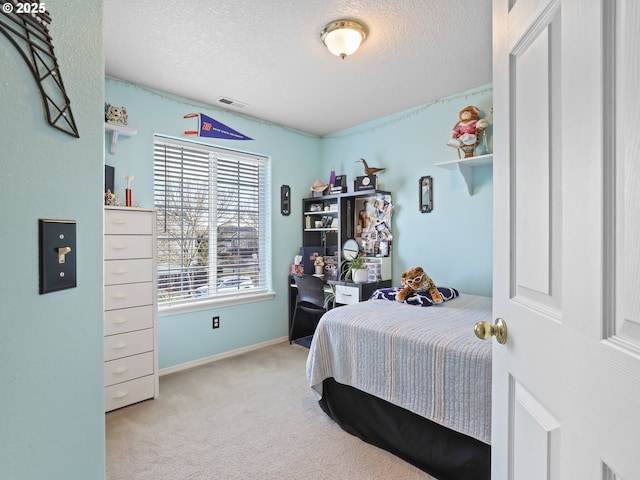 bedroom with carpet, a textured ceiling, baseboards, and visible vents