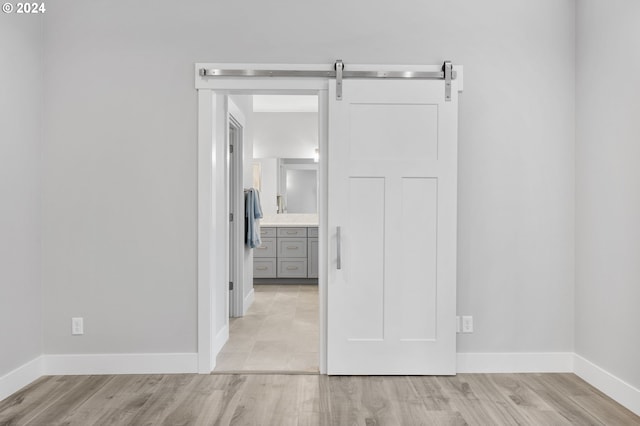 interior space featuring a barn door and light hardwood / wood-style flooring