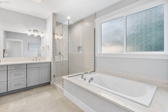 bathroom with tile patterned flooring, vanity, and independent shower and bath