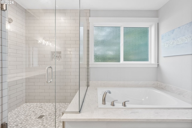 bathroom with shower with separate bathtub