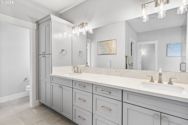 5826 SW Grayson Ter, Beaverton, OR 97078 - full bathroom featuring toilet, double vanity, and baseboards