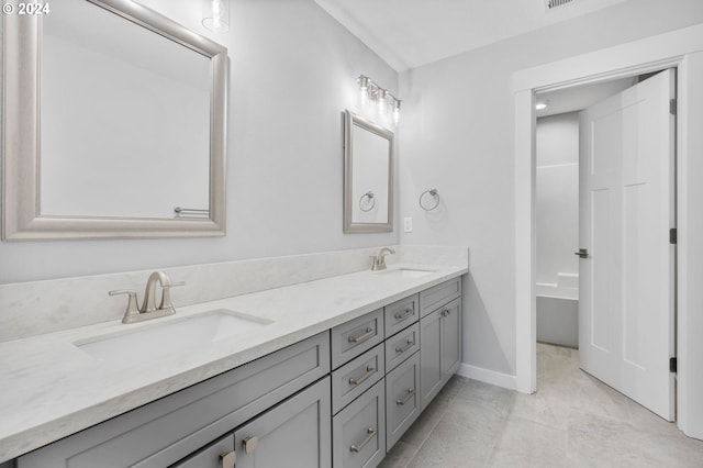 bathroom with a washtub and vanity