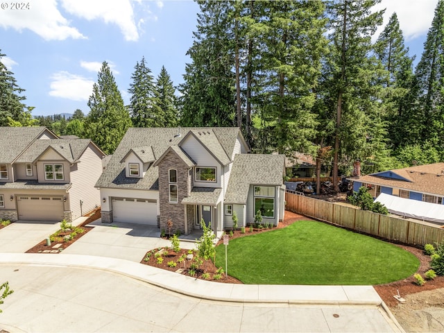 view of front of house with a garage and a front lawn