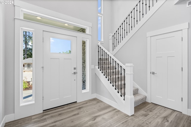 5826 SW Grayson Ter, Beaverton, OR 97078 - entryway featuring wood finished floors, stairway, baseboards, and a high ceiling