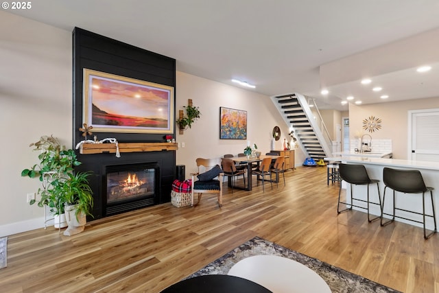 living room featuring a fireplace and light hardwood / wood-style floors