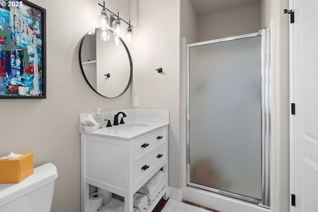 bathroom featuring walk in shower, vanity, and toilet