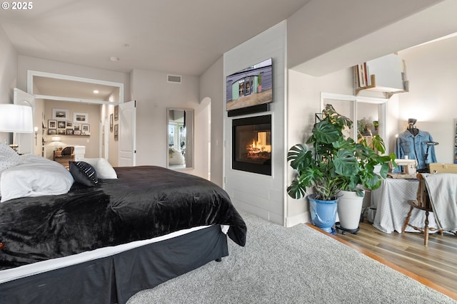 bedroom with hardwood / wood-style floors