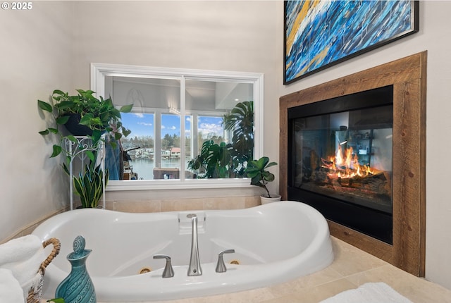 bathroom with a high end fireplace, tiled bath, and a water view