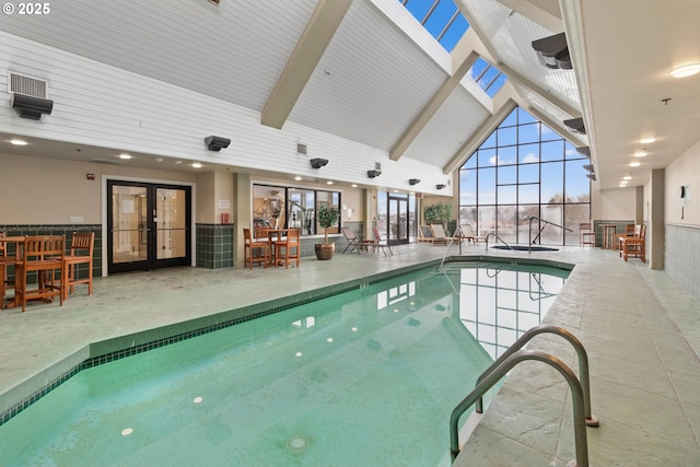 view of swimming pool featuring french doors