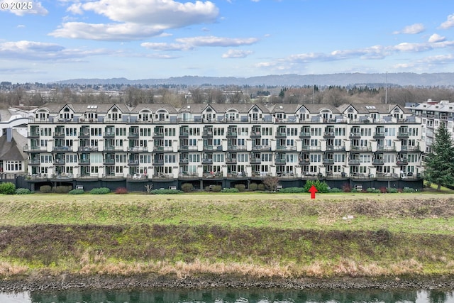 view of building exterior featuring a water and mountain view