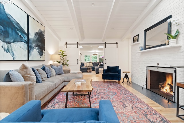 475 Iron Mountain Blvd, Lake Oswego, OR 97034 - living area with a barn door, wood finished floors, and a brick fireplace