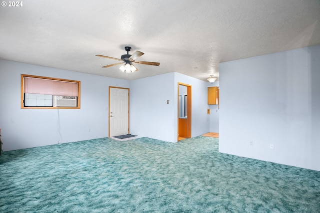 carpeted empty room featuring ceiling fan, a textured ceiling, and cooling unit