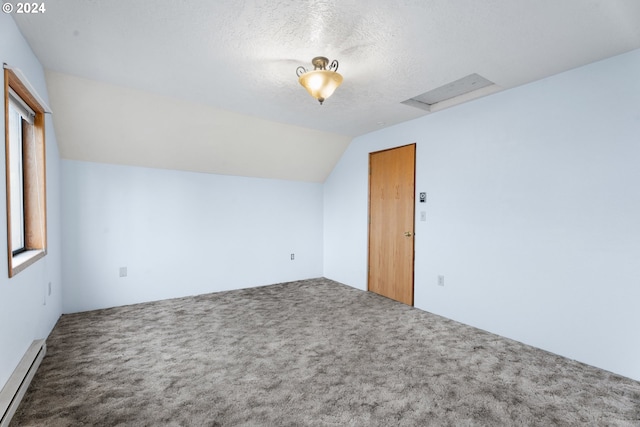 additional living space featuring a baseboard radiator, carpet floors, attic access, a textured ceiling, and vaulted ceiling